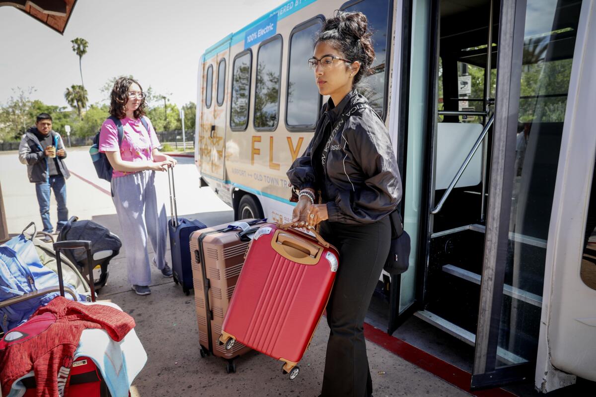 Passenger board the free airport shuttle bus at the Old Town Transit Center on Wednesday, April24,