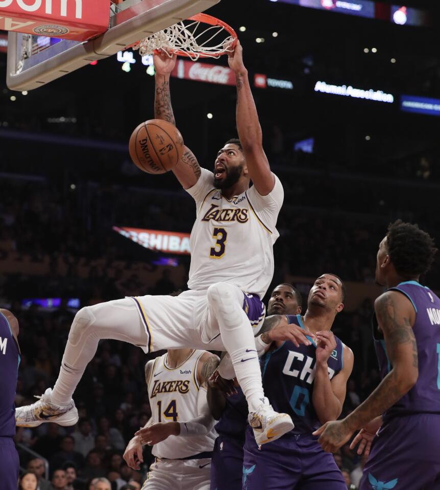 LOS ANGELES, CA, SUNDAY, OCTOBER 27, 2019 - Los Angeles Lakers forward Anthony Davis (3) slams the ball home over Charlotte Hornets forward Miles Bridges (0) during second quarter action at Staples Center.(Robert Gauthier/Los Angeles Times)