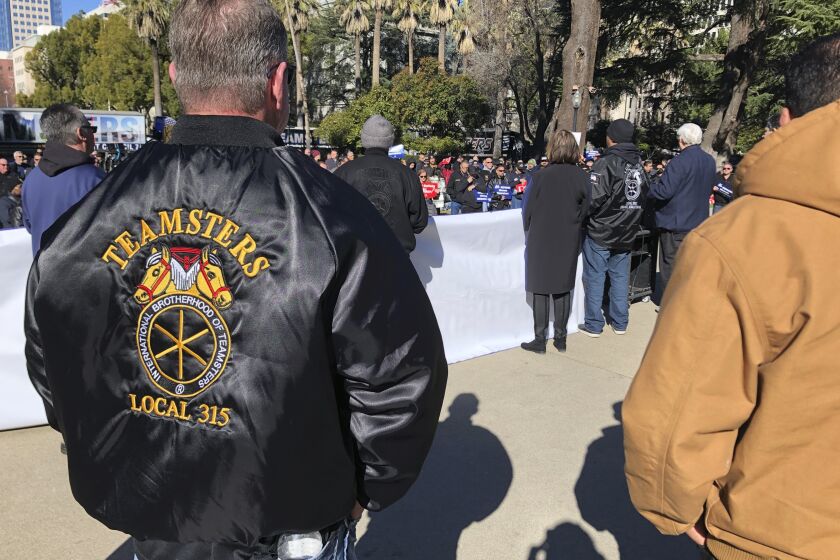 Joe Garner, a truck driver and shop steward for the local 315 of the International Brotherhood of Teamsters, watches a rally at the California Capitol on Monday, Jan. 30, 2023, in Sacramento, Calif. Garner supports a bill that would require human drivers to be present for self-driving semitrucks. (AP/Adam Beam)
