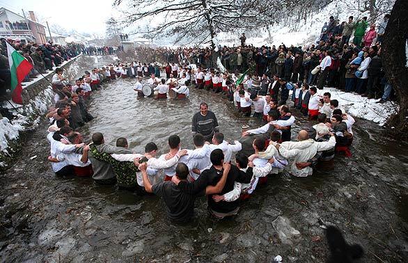 Bulgarians sing and dance in the Tundzha River as they celebrate Epiphany day in the town of Kalofer. As part of the celebration, Eastern Orthodox priests throw a cross into the river and the men dive in to retrieve it. It is believed that those who dance in the river will be healthy throughout the year.