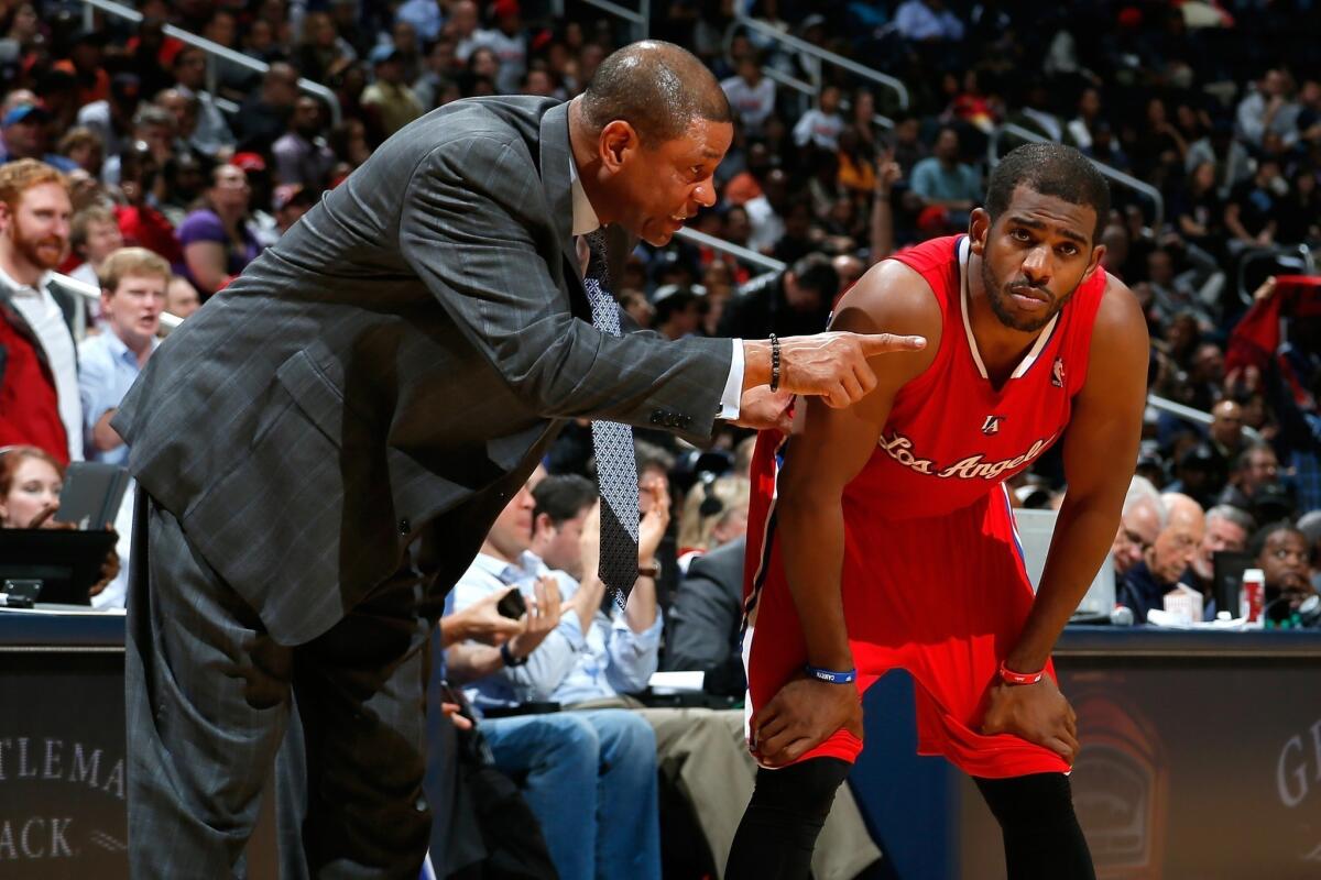 Clippers Coach Doc Rivers, left, speaks to Clippers point guard Chris Paul during Wednesday's 107-97 loss to the Atlanta Hawks.