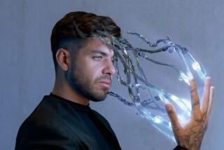 A musician with beams of light light and robot fingers emerging from his hand. 