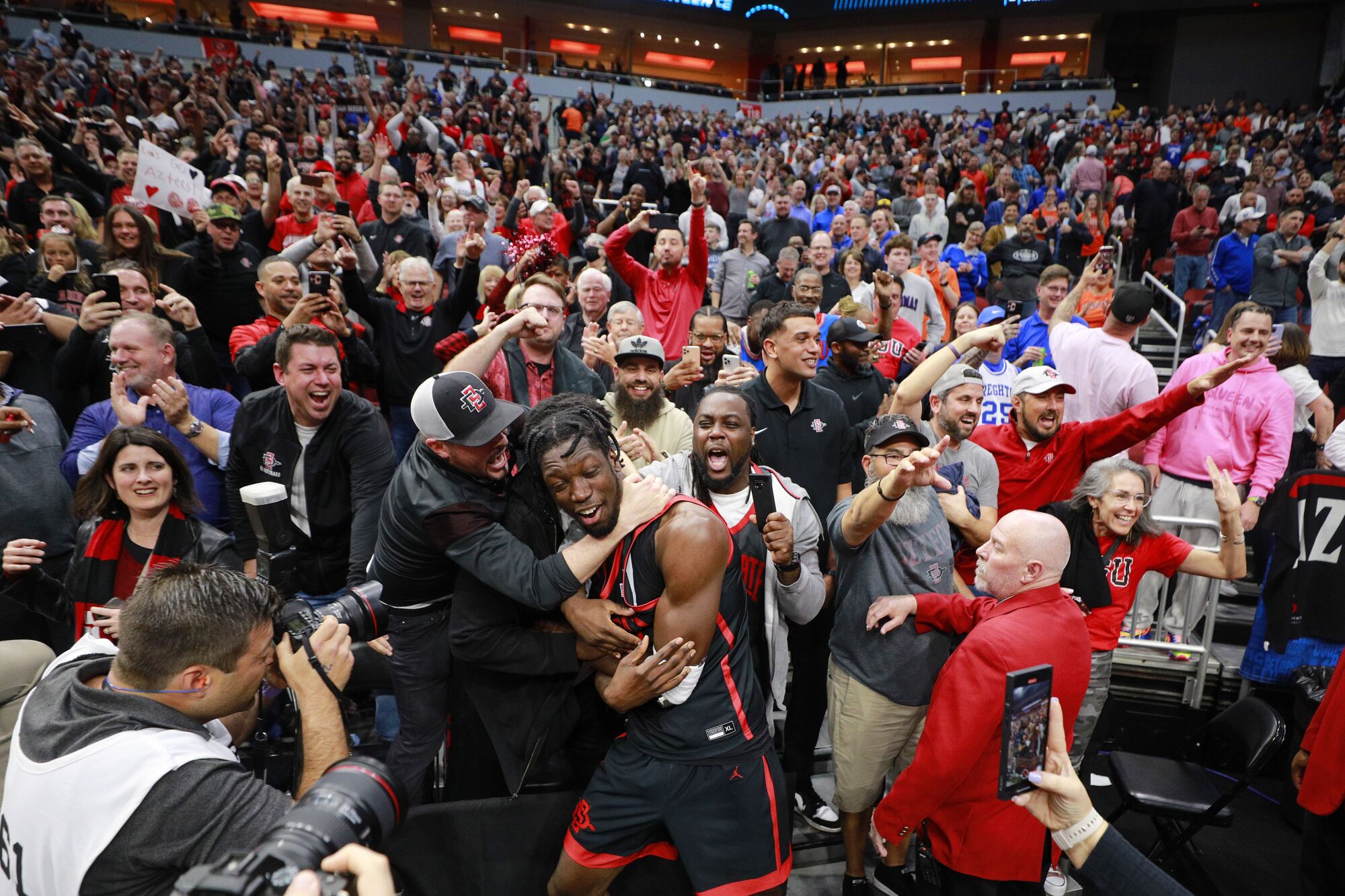 San Diego State's Nathan Mensah celebrates with family and fans after beating Alabama