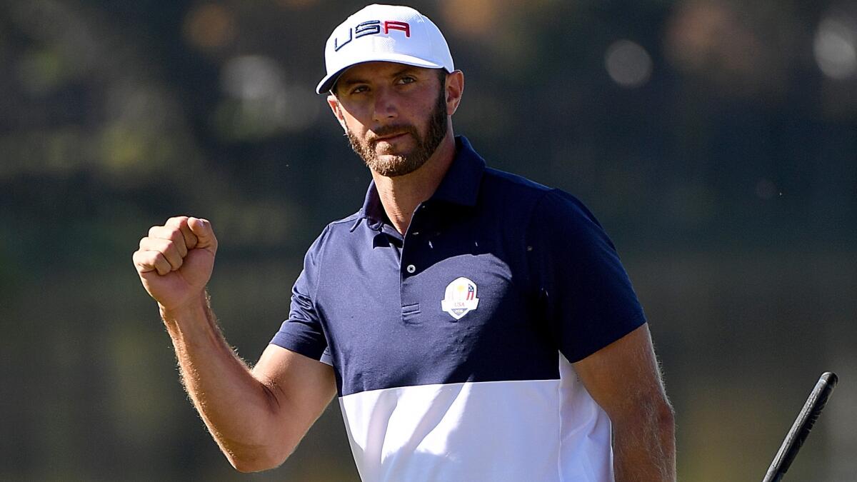 Dustin Johnson reacts after making a putt during the Ryder Cup.