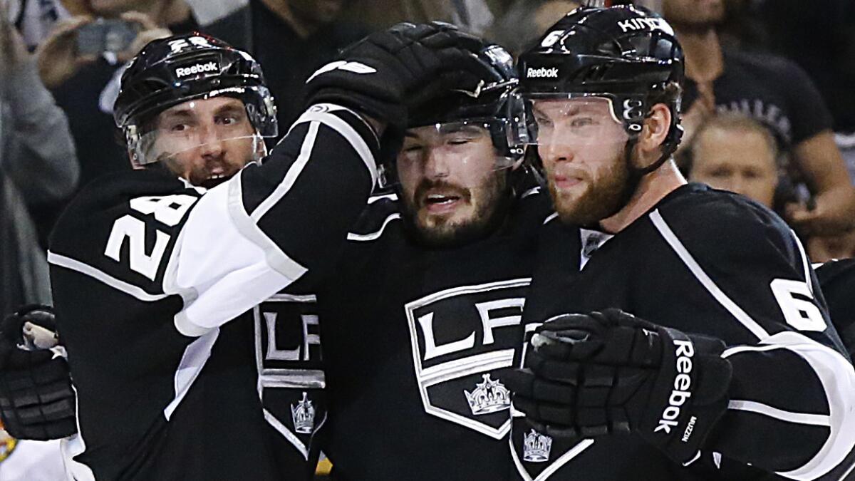Kings teammates (from left to right) Jarret Stoll, Drew Doughty and Jake Muzzin celebrate following a goal by Doughty during the third period of the Kings' win over the Chicago Blackhawks in Game 3 of the Western Conference finals on May 24.