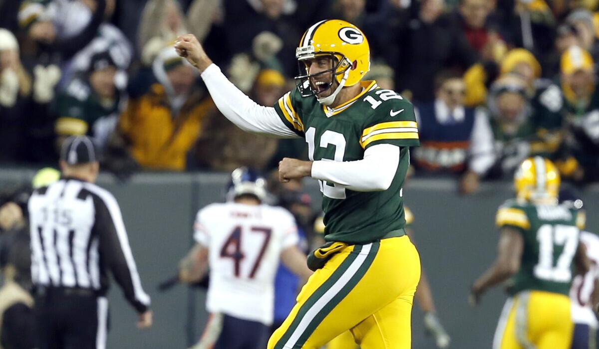Packers quarterback Aaron Rodgers celebrates one of his six touchdown passes in the first half against the Chicago Bears on Sunday evening in Green Bay.