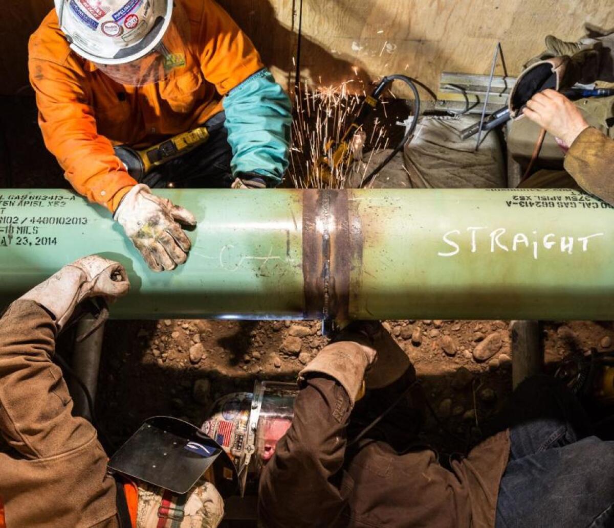People work on a natural gas pipeline.
