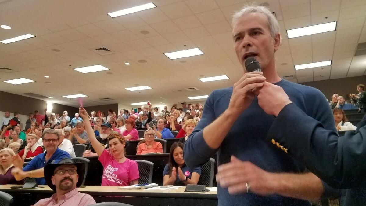 Rick Somers, 53, a small-business owner, asks Republican Rep. Buddy Carter a question about the Affordable Care Act at a town hall in Savannah , Ga.