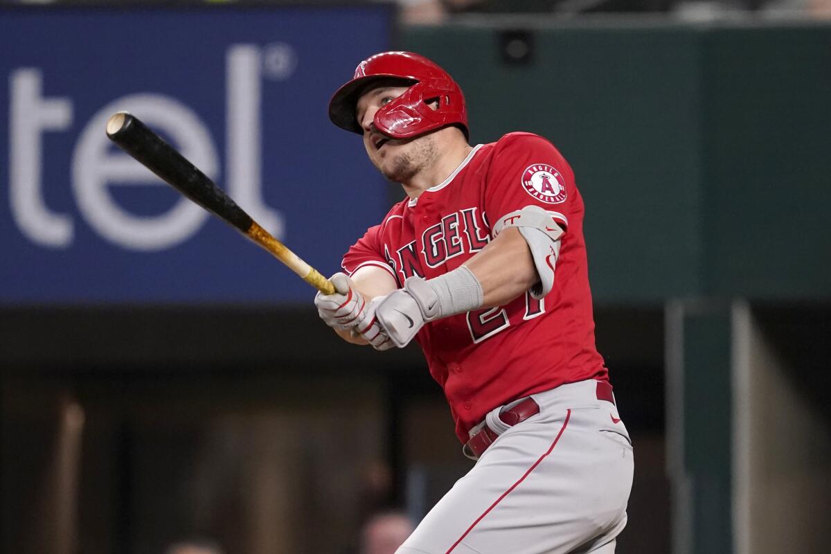 Angels' Mike Trout watches a solo home run during the seventh inning against the Texas Rangers.