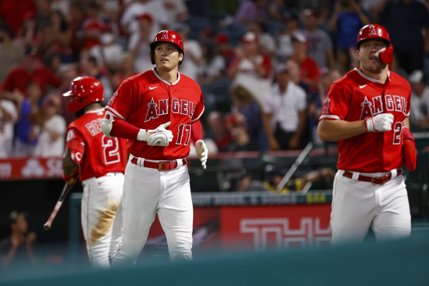 FILE - Los Angeles Angels' Shohei Ohtani (17) and Mike Trout run back to the dugout after scoring against the Detroit Tigers during the third inning of a baseball game in Anaheim, Calif., Sept. 5, 2022. This could be the last time for Shohei Ohtani and Mike Trout to play together with a chance to lead the Los Angeles Angels back to the playoffs. (AP Photo/Ringo H.W. Chiu, File)