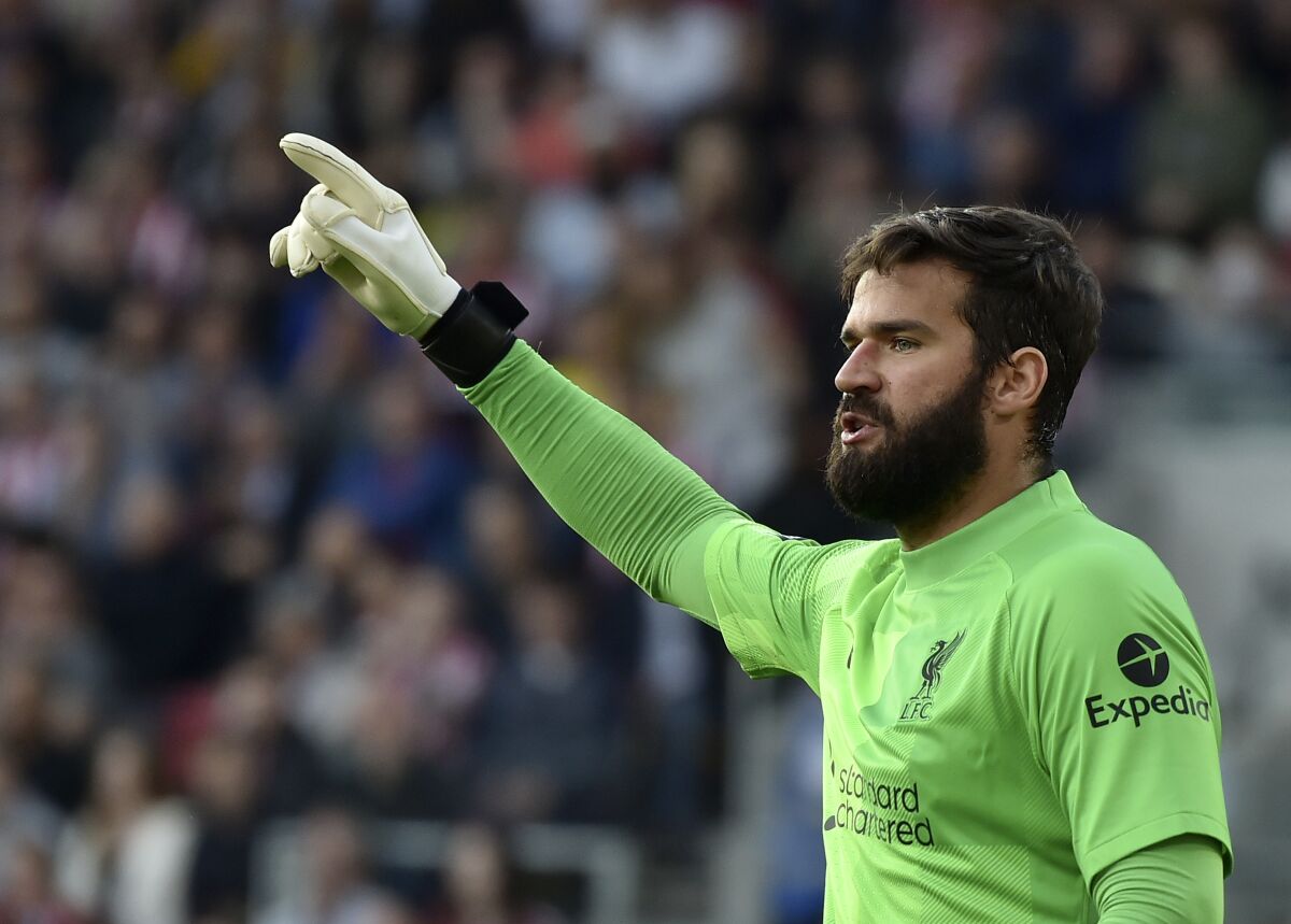 Liverpool's goalkeeper Alisson reacts during the English Premier League soccer match between Brentford and Liverpool at the Brentford Community Stadium in London, Saturday, Sept. 25, 2021. (AP Photo/Rui Vieira)