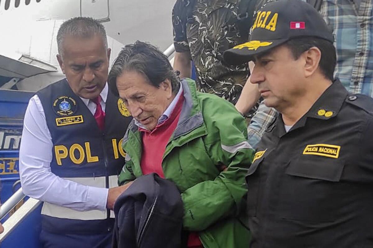 En esta foto difundida por la Policía Nacional de Perú, agentes escoltan al expresidente Alejandro Toledo 
