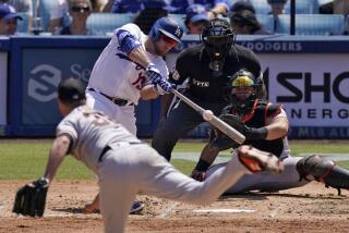 Los Angeles Dodgers' Max Muncy, second from left, hits an RBI double as San Francisco Giants.