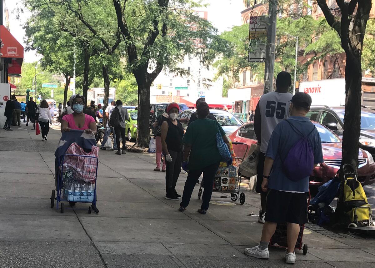 The line for food at the Community Kitchen and Pantry in Harlem stretched down the block of West 116th Street. 