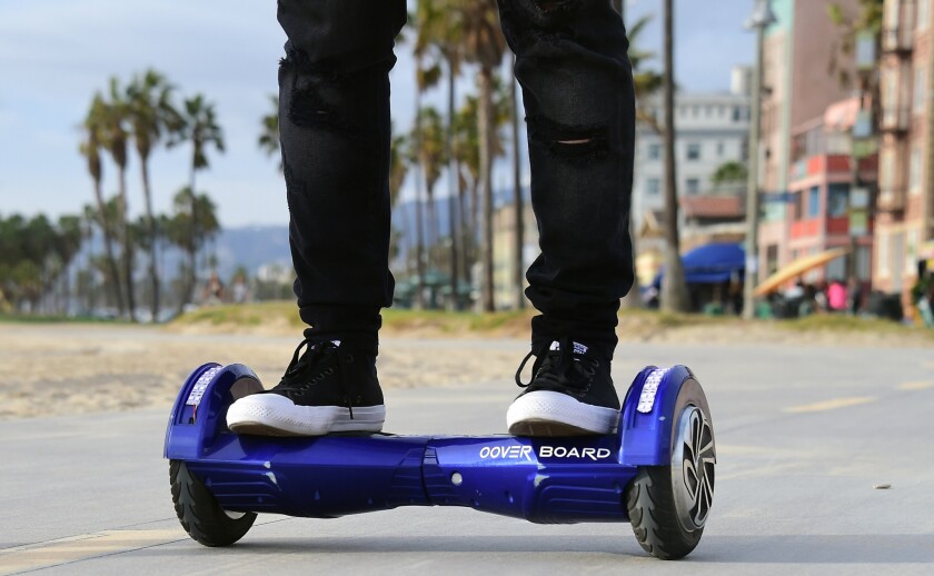 Michael Tran uses a hoverboard on the Venice Beach boardwalk this month.