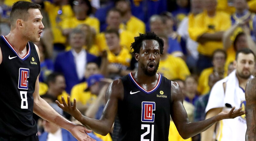 Clippers guard Patrick Beverley (21) and forward Danilo Gallinari (8) question a call during Game 1 against the Warriors on Saturday evening in Oakland.