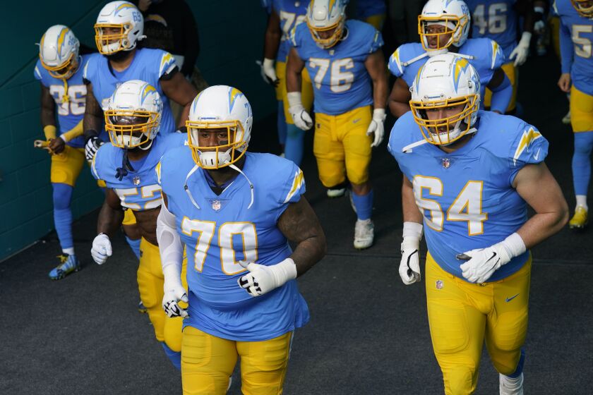 Los Angeles Chargers offensive guards Trai Turner (70) and Cole Toner (64) enter the field.