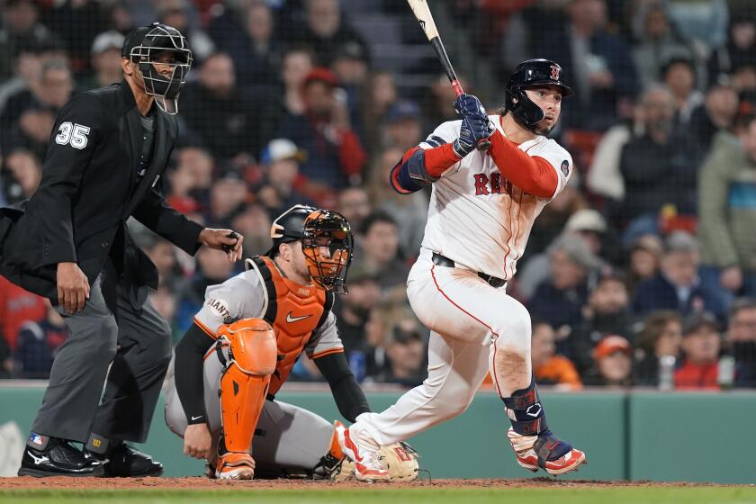 Boston Red Sox's Wilyer Abreu follows through on his RBI triple in front of San Francisco Giants catcher Patrick Bailey during the fourth inning of a baseball game, Tuesday, April 30, 2024, in Boston. (AP Photo/Michael Dwyer)