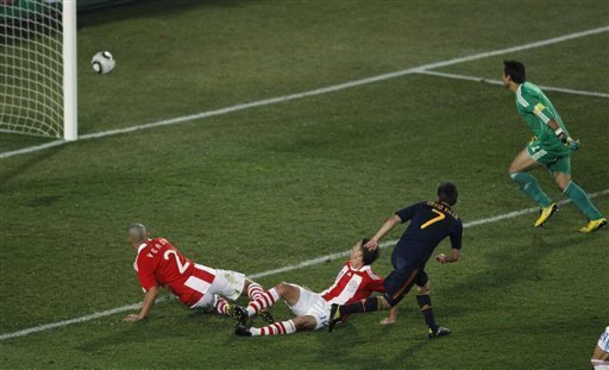 Spain's David Villa, second from right, scores a goal past Paraguay goalkeeper Justo Villar, right, during the World Cup quarterfinal soccer match between Paraguay and Spain at Ellis Park Stadium in Johannesburg, South Africa, Saturday, July 3, 2010. (AP Photo/Hassan Ammar)