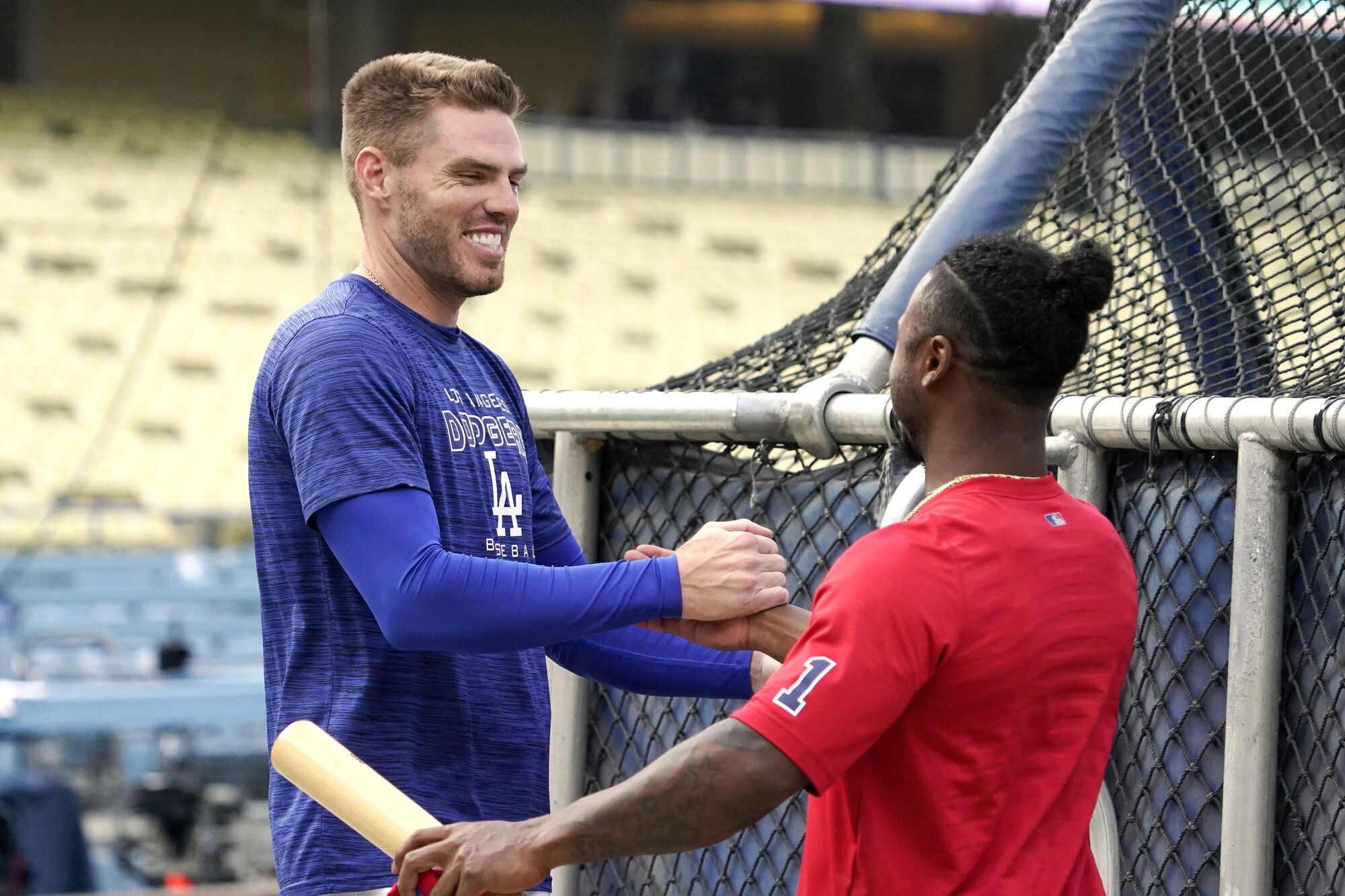 Dodgers first baseman Freddie Freeman, left, greets Atlanta Braves second baseman Ozzie Albies.