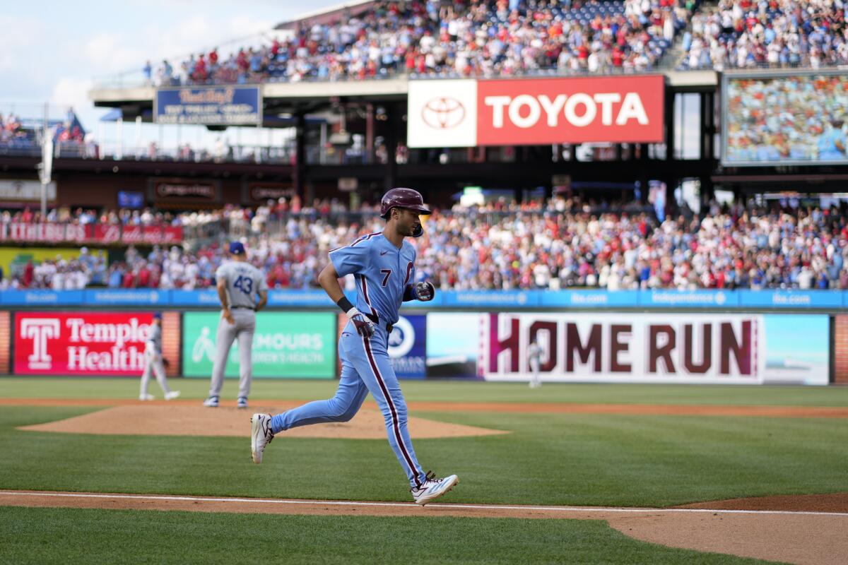 Philadelphia's Trea Turner rounds the bases after hitting a home run off Dodgers pitcher Anthony Banda.