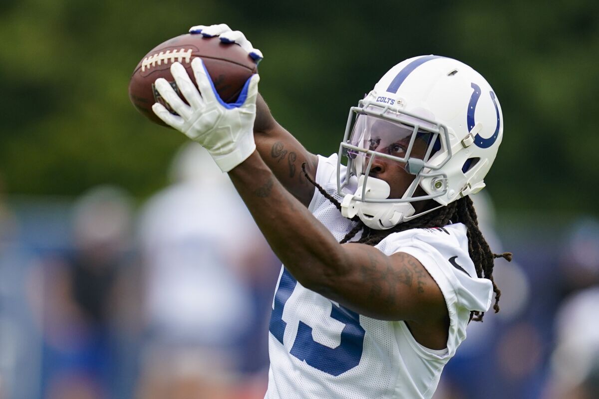 FILE - Indianapolis Colts wide receiver T.Y. Hilton makes a catch as he runs a drill during practice at the NFL team's football training camp in Westfield, Ind., in this Thursday, July 29, 2021, file photo. Hilton was back on the practice field for Wednesday's, Oct. 13, 2021, light workout. The four-time Pro Bowler has been designated for return from injured reserve after having neck surgery in August and coach Frank Reich is optimistic Hilton will be cleared to play this weekend against the Houston Texans. (AP Photo/Michael Conroy, File)