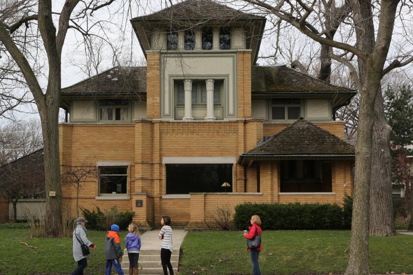 Home owner Debbie Abrahamson greets 5th grade students and faculty from Oak Park's Washington Irving Elementary School as they arrive for a tour inside her Rollin Furbeck house in Oak Park, Tuesday March 22, 2016. The Rollin Furbeck House, built by architect Frank Lloyd Wright in 1897, is a designated Oak Park landmark. (Antonio Perez/Chicago Tribune)