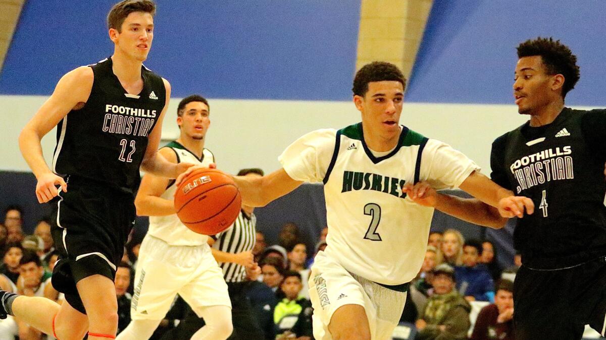 UCLA-bound point guard Lonzo Ball drives to the basket against Foothills Christian's T.J. Leaf (left) and Omajae Smith earlier this season.