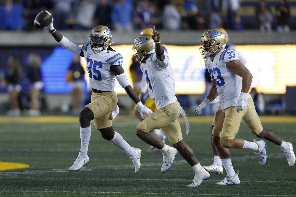 UCLA linebacker Carl Jones Jr. celebrates with teammates after he recovered a Cal fumble to seal the Bruins' win Nov. 25.