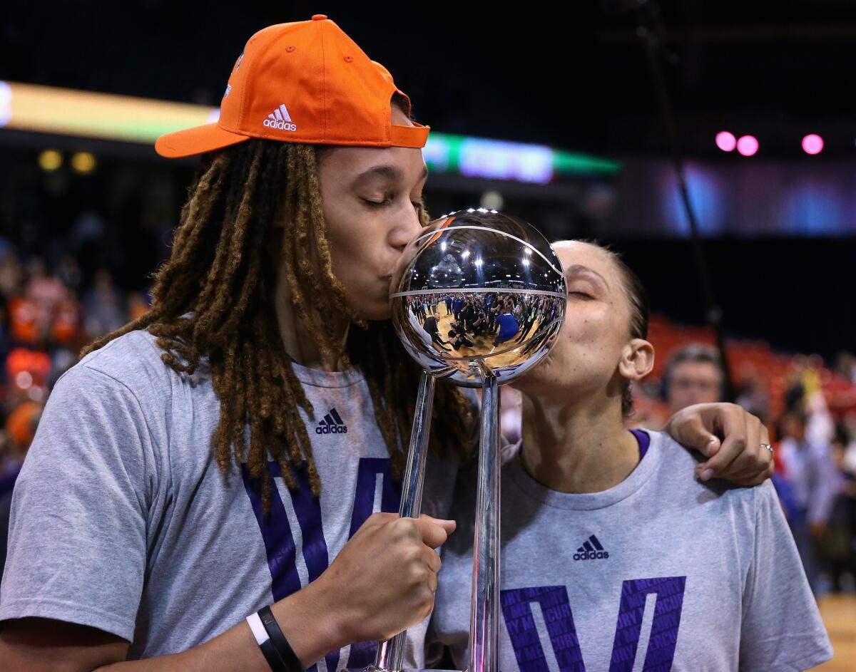 Brittney Griner and Diana Taurasi of the Mercury kiss the WNBA championship trophy after Phoenix's 87-82 win Friday over the Chicago Sky.