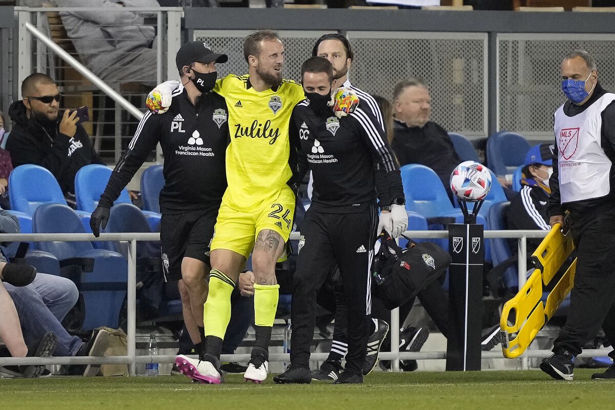 Seattle Sounders goalkeeper Stefan Frei (24) is taken off the field after a collision with a San Jose Earthquakes player during the second half of an MLS soccer match Wednesday, May 12, 2021, in San Jose, Calif. The Sounders won 1-0. (AP Photo/Tony Avelar)