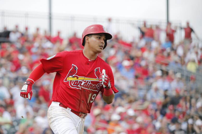 Cardinals infielder Ruben Tejada runs for first base after hitting a single during the seventh inning of a spring training game.