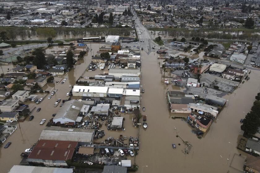 This aerial photo shows the majority of the north Monterey County town of Pajaro, Calif., just across the Pajaro River from Watsonville, Calif., submerged with floodwaters, Sunday, March 12, 2023, after the river levee breached early Saturday. (Shmuel Thaler/The Santa Cruz Sentinel via AP)