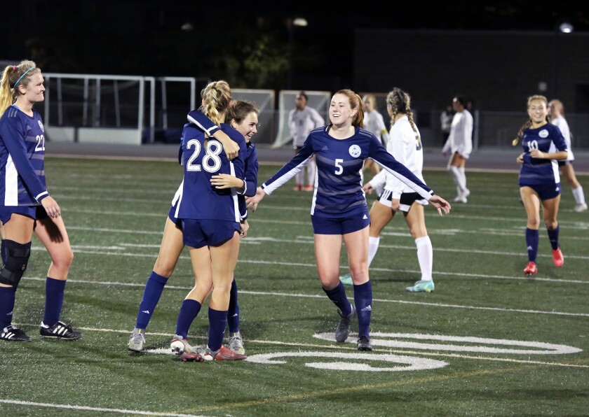 The Newport Harbor girls' soccer team celebrates after beating Capistrano Valley on Wednesday.