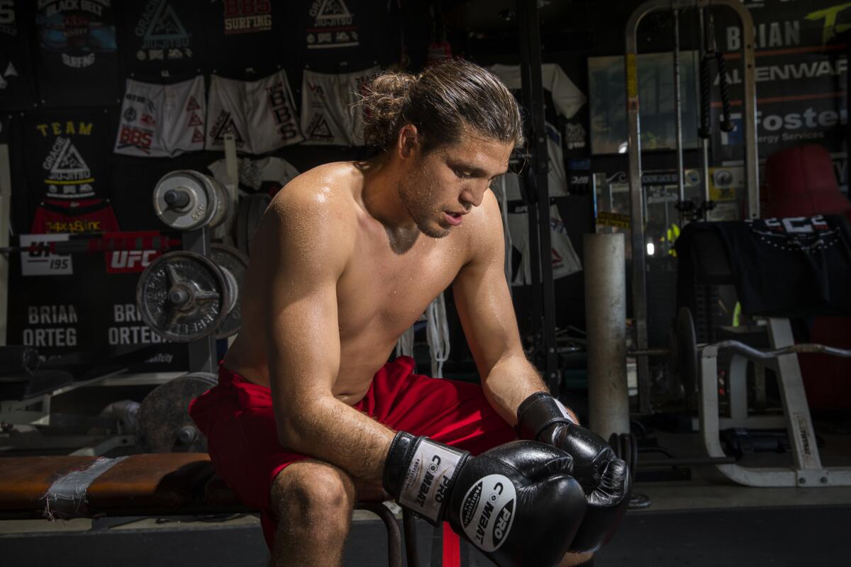 Brian "T-City" Ortega, a UFC featherweight fighter, pauses during his workout.