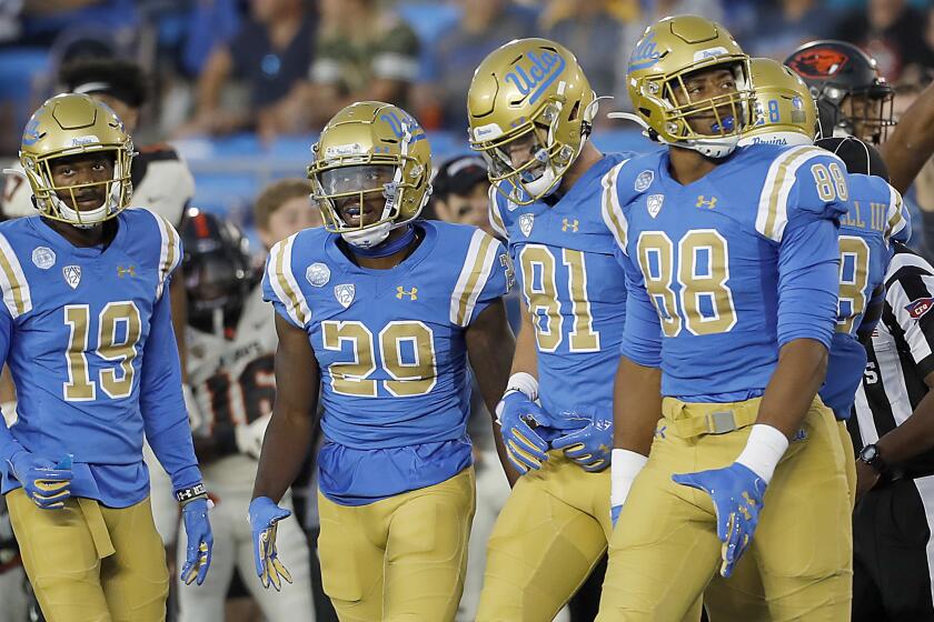 PASADENA,, CALIF. - OCT. 5, 2019. The UCLA kickoff return gteam heads back to the Bruins bench after Oregon State recovered a drop kick to take possession of the ballin the first quarter at the Rose Bowl in Pasadena on Saturday night, Oct. 5, 2019. (Luis Sinco/Los Angeles Times)