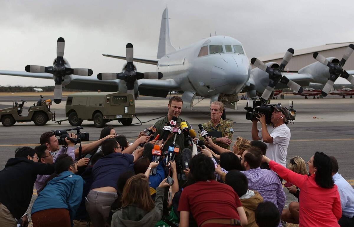 Flight Lt. Russell Adams of the Australian air force speaks to reporters in Perth after his AP-3C Orion returned from searching for wreckage from the missing Malaysia Airlines Flight 370.