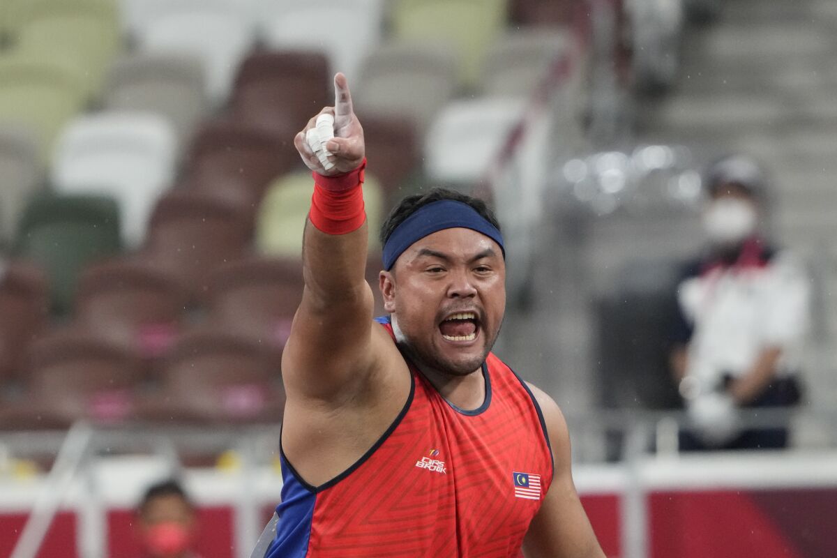 FILE - In this Tuesday, Aug. 31, 2021, file photo, Muhammad Ziyad Zolkefli of Malaysia reacts after competing in the men's shot put F20 final during the Tokyo 2020 Paralympics Games at the National Stadium in Tokyo. Zolkefli appeared to have won gold in the shot put in the F20 class. But after the victory on Tuesday, he was disqualified because he had shown up late for the competition. (AP Photo/Eugene Hoshiko, File)