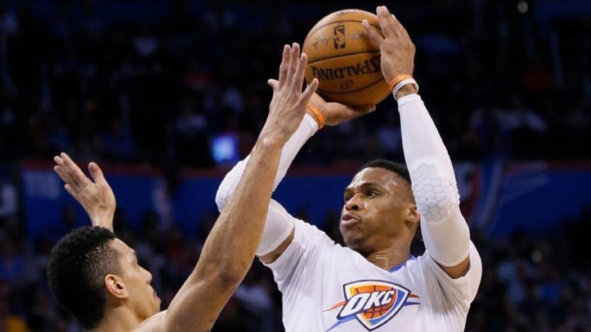 Thunder guard Russell Westbrook shoots in front of Spurs guard Danny Green during the first quarter of a game on March 9.