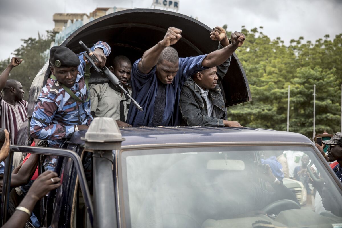 Security forces and others drive in celebration through Bamako, Mali’s capital.