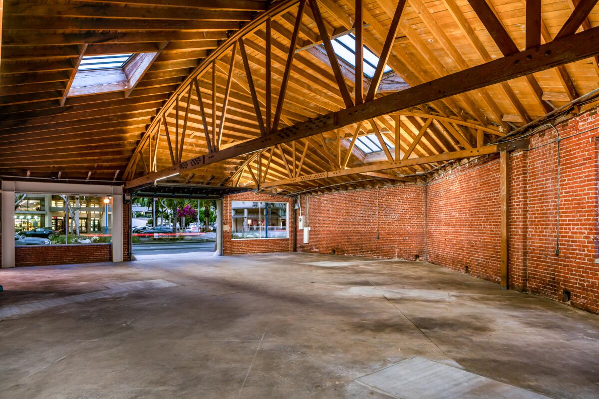 A view of the brick wall, wood truss interiors of Hauser & Wirth's new gallery space