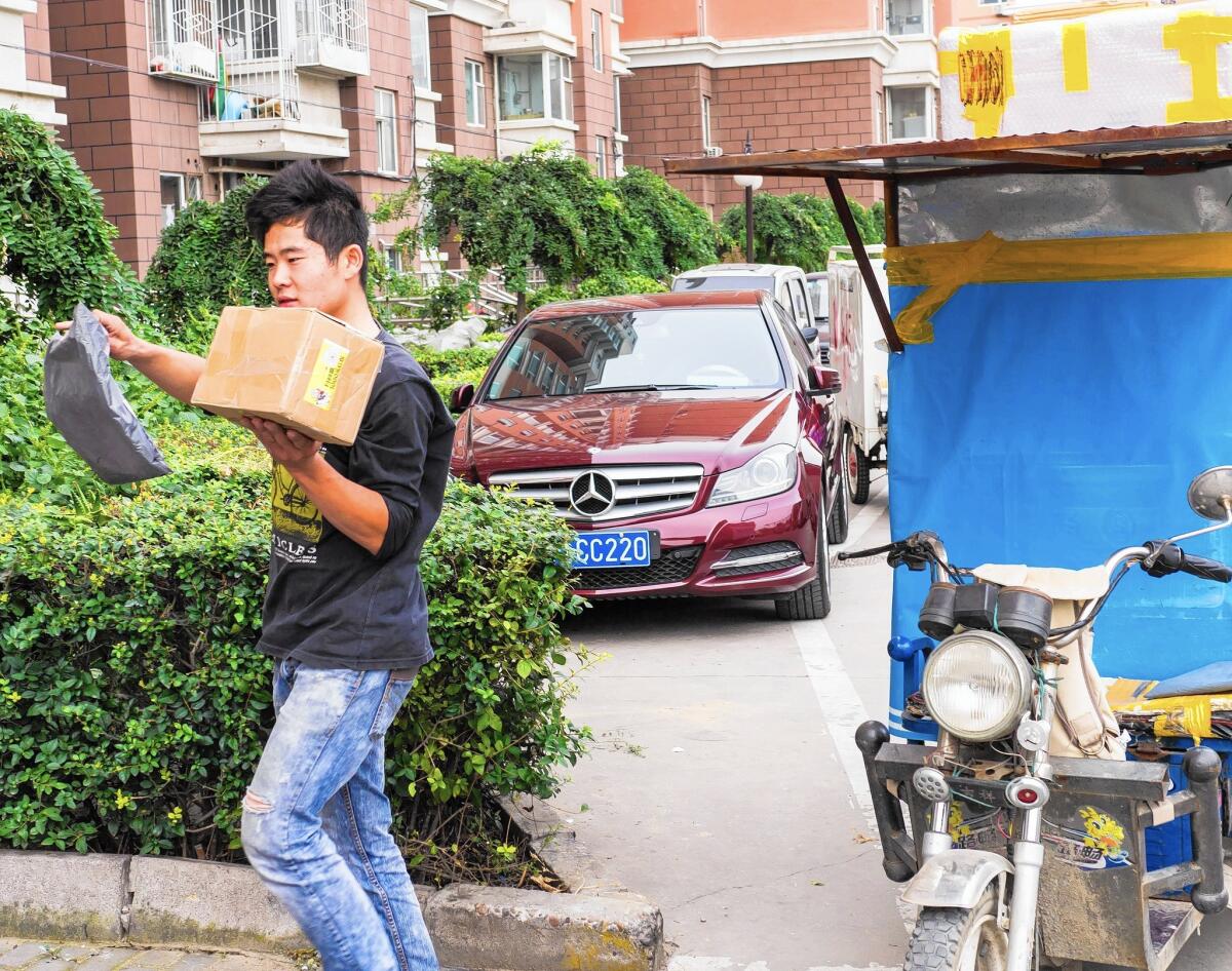 Diao Binghui delivers a package in the eastern suburbs of Beijing. For each package he drops off, Diao pockets about 15 cents.