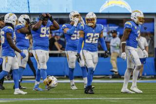 The Chargers dejectedly walk off the field after losing to the Lions, 41-38.