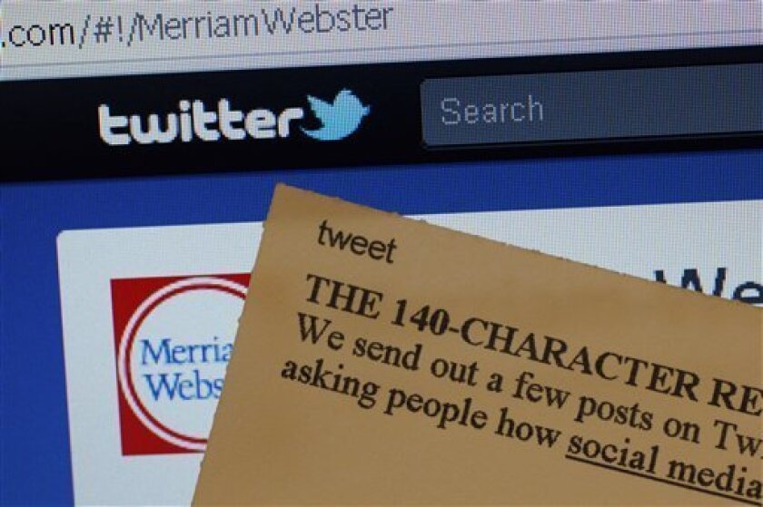 This Wednesday, Aug. 24, 2011 photo displays an index card with the entry "tweet" next to a computer screen showing the Twitter website, at the Merriam-Webster headquarters in Springfield, Mass. Used as both a noun and a verb, the word describing a post made on the online Twitter message service is among more than 100 new terms revealed Thursday for the dictionary publisher's newest edition. (AP Photo/Charles Krupa)