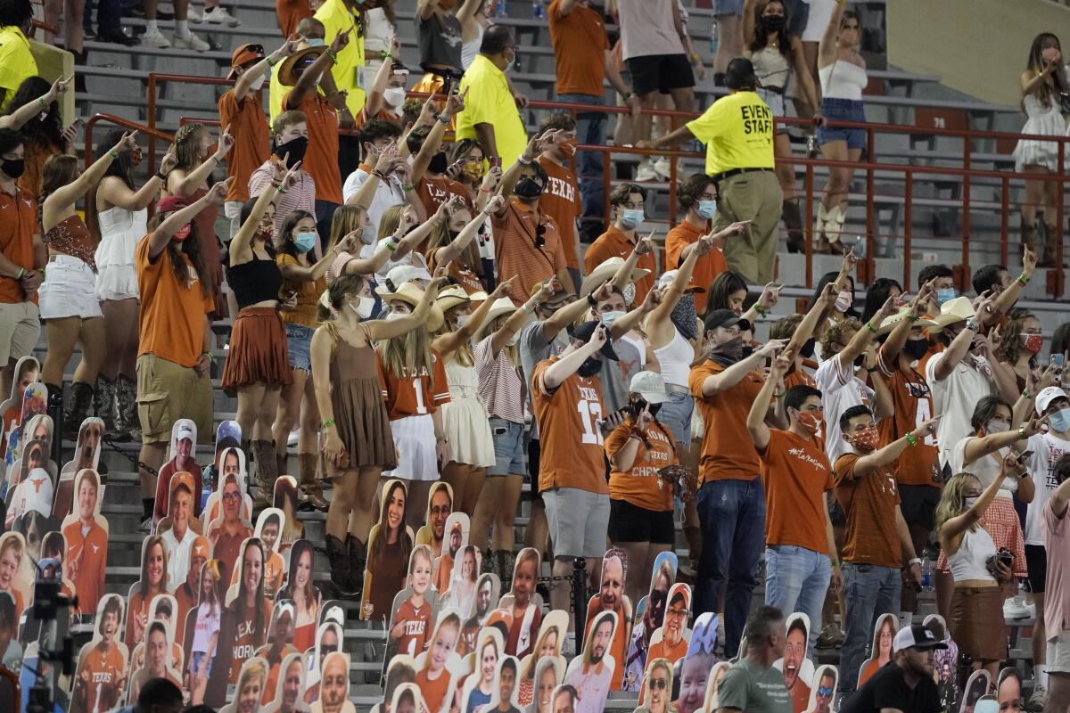 Fans sing "The Eyes of Texas" after a basketball game