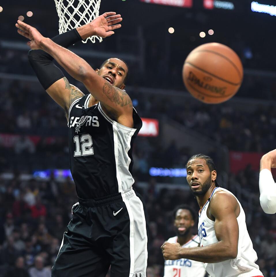 Spurs forward LaMarcus Aldridge is fouled by Clippers forward Kawhi Leonard while driving to the basket during the first quarter.