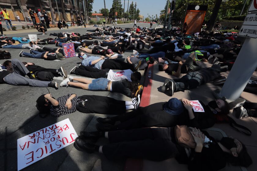 ANAHEIM CA. JUNE 3, 2020 - A group of demonstrators stage a sit-in in front of the Anaheim Civic Center Wednesday, June 3, 2020, to protest the in-custody death of George Floyd. (Irfan Khan / Los Angeles Times)