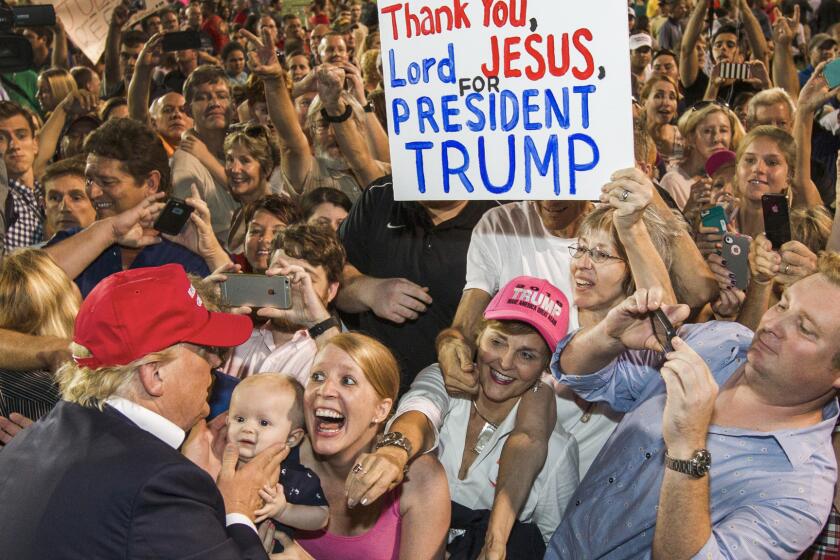 Republican presidential candidate Donald Trump greets supporters after his rally at Ladd-Peebles Stadium on Aug. 21, 2015, in Mobile, Ala.