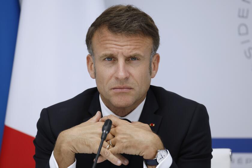French President Emmanuel Macron attends a video conference as part as the AI Summit Seoul 2024 from the Elysee Palace in Paris, Tuesday, May, 21, 2024. (Yoan Valat, Pool via AP)