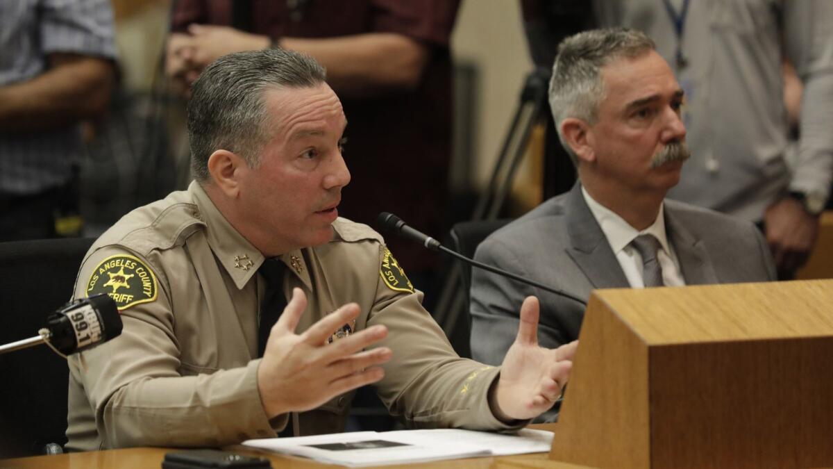 For much of his few months in office, L.A. County Sheriff Alex Villanueva, left, has faced questions about his decision to reinstate a deputy fired for violating policies against domestic violence and dishonesty. Another reinstated deputy was fired for unreasonable force.